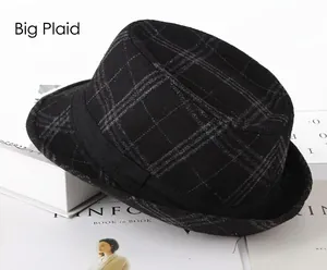 Close-up of a men's trilby hat featuring a large black plaid wool pattern and decorative band