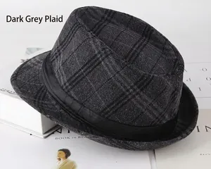 Detail shot of black and grey plaid fedora hat with a black ribbon band on books