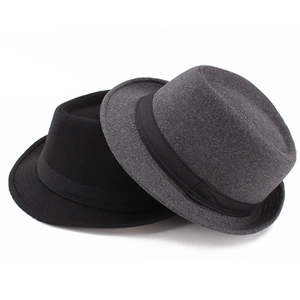 Close-up of black and grey autumn fedora hats featuring flannel texture and ribbon bands