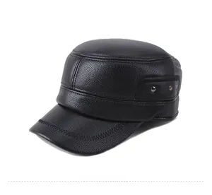 Detail view of black faux leather flat top cap featuring side rivets and textured finish