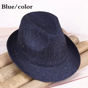 Navy blue fedora hat with diamond pattern and air eyelets on vintage newspaper