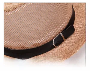 Close-up of breathable mesh splicing and metallic buckle detail on brown straw hat