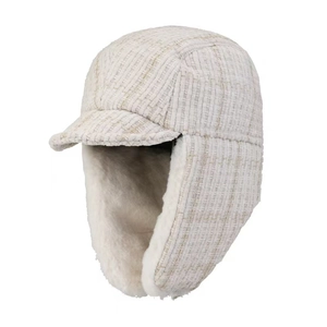 Detail of tweed shell with gold thread and thick faux rabbit fur lining on winter hat