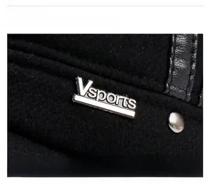 Detail of wool fabric texture with silver Vsports metal logo and leather accents
