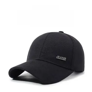 Detail of black cotton baseball cap showing a metal JEANS newwear plate on the side