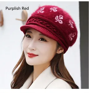 Detail of burgundy rabbit fur blend knit beret with pink floral jacquard and short brim