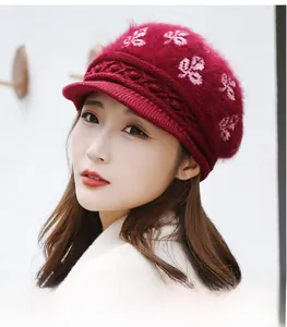 Close-up of red winter knit hat with flower embroidery and warm fleece lining