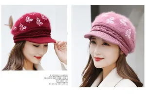 Detail of warm winter knit beanies in burgundy and pink with soft rabbit fur texture