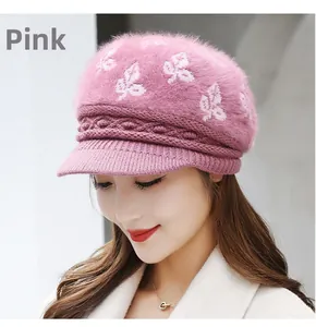 Detail of dusty pink knit visor hat with rabbit fur texture and leaf jacquard pattern