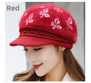 Detail of red rabbit fur knit winter hat with white leaf jacquard and cable knit brim