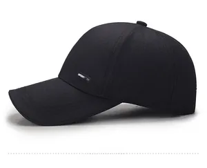 Detailed side view of black baseball cap with SPORT label and fine twill fabric texture