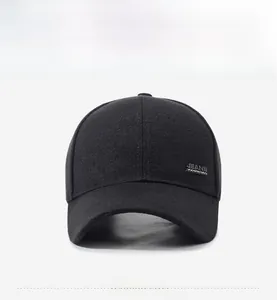 Detail of black wool baseball cap side view featuring rectangular silver metal logo plate