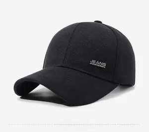 Detail of black cotton baseball cap showing silver metal logo and high-quality stitching