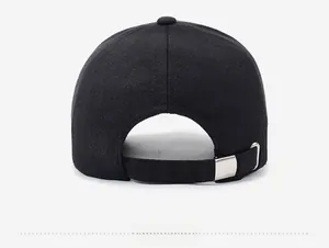 Close-up of black cotton baseball cap with adjustable silver metal buckle on the back