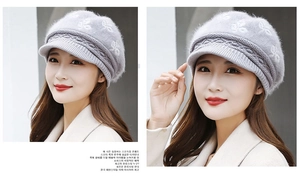 Detailed texture of light gray knit beanie with fluffy rabbit hair and leaf pattern