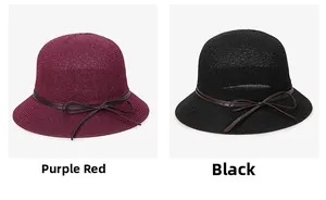 Detail of burgundy and black woven sun hats with decorative ribbon and bow accents