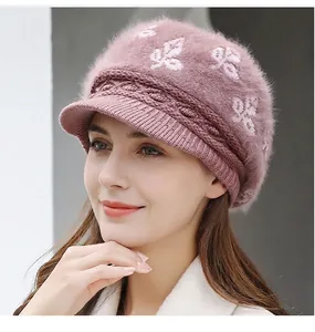 Close-up of thick knitted winter hat showing fuzzy texture and white leaf patterns