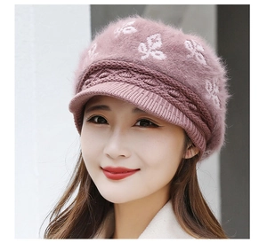 Detail of mauve faux rabbit fur knit hat with leaf embroidery and textured brim for women
