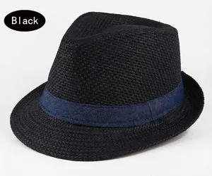 Detail of black straw fedora hat featuring dense weave and navy blue ribbon band