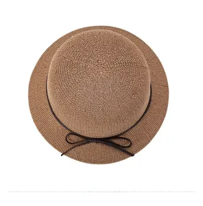 Top view of brown knitted sun hat featuring detailed weave texture and thin bow detail