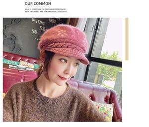 Detail of dark pink knitted winter hat featuring thick cable knit and warm fuzzy texture