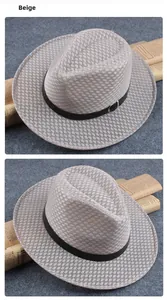 Detailed view of beige woven straw fedora hat with a black leather decorative band
