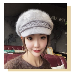 Detail of grey winter knit visor hat showing soft plush texture and cable knit patterns