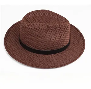 Side view of a brown woven fedora hat with a black decorative band and textured finish