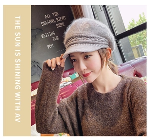 Detail of grey knitted baker boy hat with soft rabbit fur texture and stylish brim