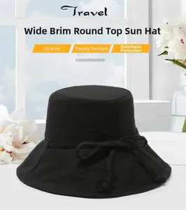 Detail of black wide brim sun hat with ribbon bow shown in bright sunlit window setting