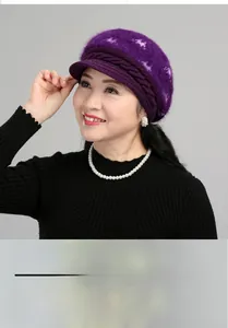 Detailed texture of dark purple knitted winter hat with thick rabbit fur rabbit yarn
