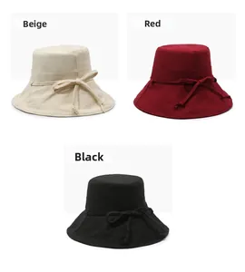 Trio set of bow-decorated sun bucket hats in beige, red, and black breathable fabric