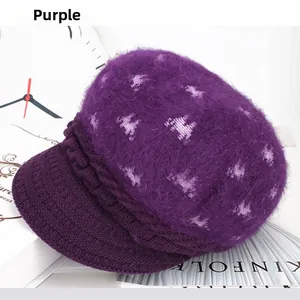 Detail of purple knitted rabbit fur hat with white pony pattern and visor cap design
