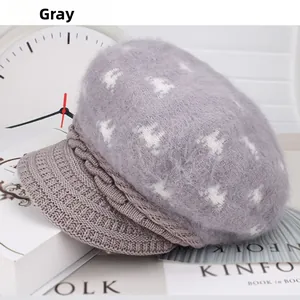 Detail of gray knitted beanie with faux fur top and star pattern on stylish lifestyle background