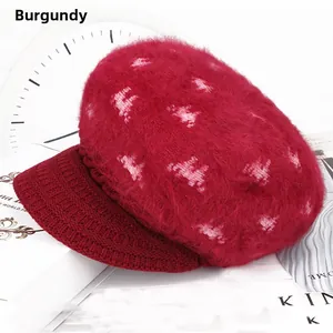 Detail of wine red knit visor beanie with fuzzy texture on a lifestyle background