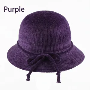 Détail d'un chapeau cloche tricoté violet avec décoration de nœud pour l'automne