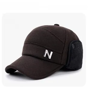 Detail of warm winter baseball cap featuring thick wool fabric and plush ear flaps