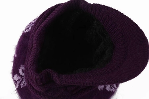 Close-up of thick black fleece lining inside the purple knitted winter hat with visor