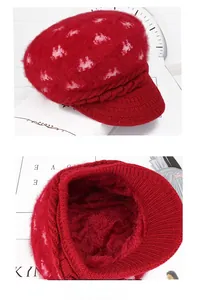 Detail of red knit visor hat featuring thick fleece lining and cozy cable knit texture