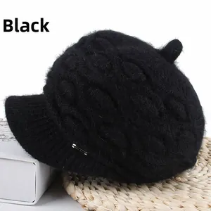 Detail shot of black faux rabbit fur knit beret featuring a stylish silver metal pin