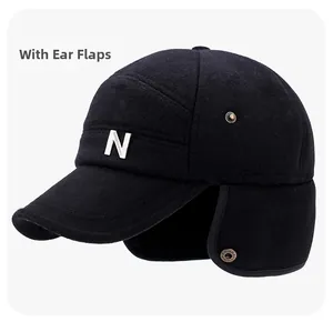 Detail view of winter baseball cap with thick wool fabric and foldable ear flaps