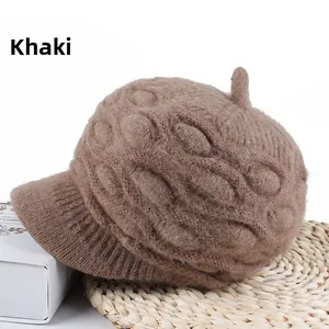 Detail of khaki cable knit thick winter beanie with visor and soft bunny fur texture