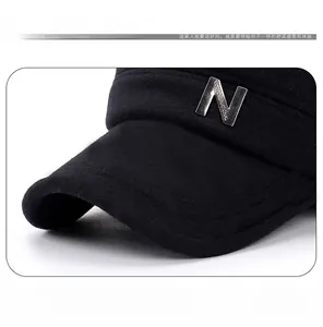 Detailed macro view of wool felt material with silver metal letter N on black winter cap