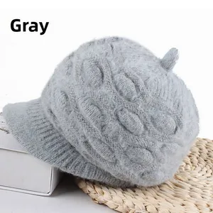 Macro detail of thick grey knitted beanie with visor and cable weave texture