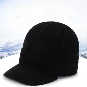 Close-up of black thick knit jeep cap with sport metal logo and warm thermal texture