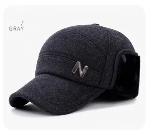 Detail view of winter baseball cap with gray wool fabric and plush earflaps
