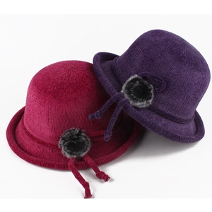 Winter knitted bucket hat with faux fur pom-pom in burgundy and purple colors