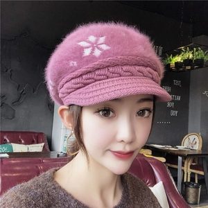 Pink winter knit hat for women with plush fur top and white snowflake pattern
