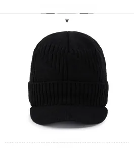 Detail view of black knit beanie with visor and silver Sport emblem for winter warmth