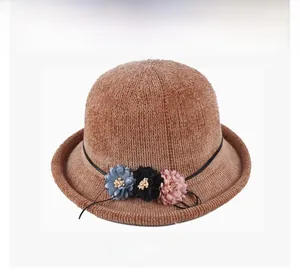 Detailed knit texture of brown cloche bucket hat featuring a 3D floral decoration